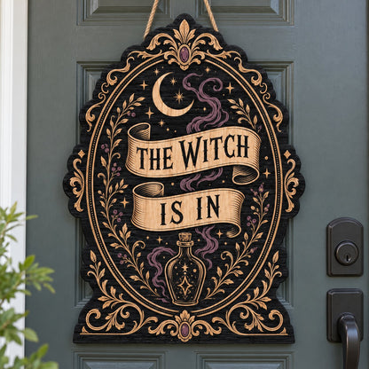 Gothic plaque sign reading "THE WITCH IS IN" with crescent moon, stars, purple smoke, potion bottle and ornate filigree 