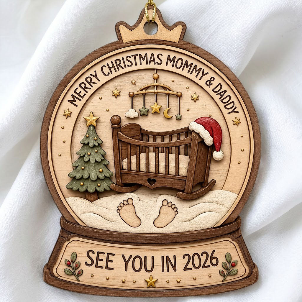 Snow globe wood ornament with crib, Santa hat, mobile, tree, footprints, and Merry Christmas Mommy & Daddy text.