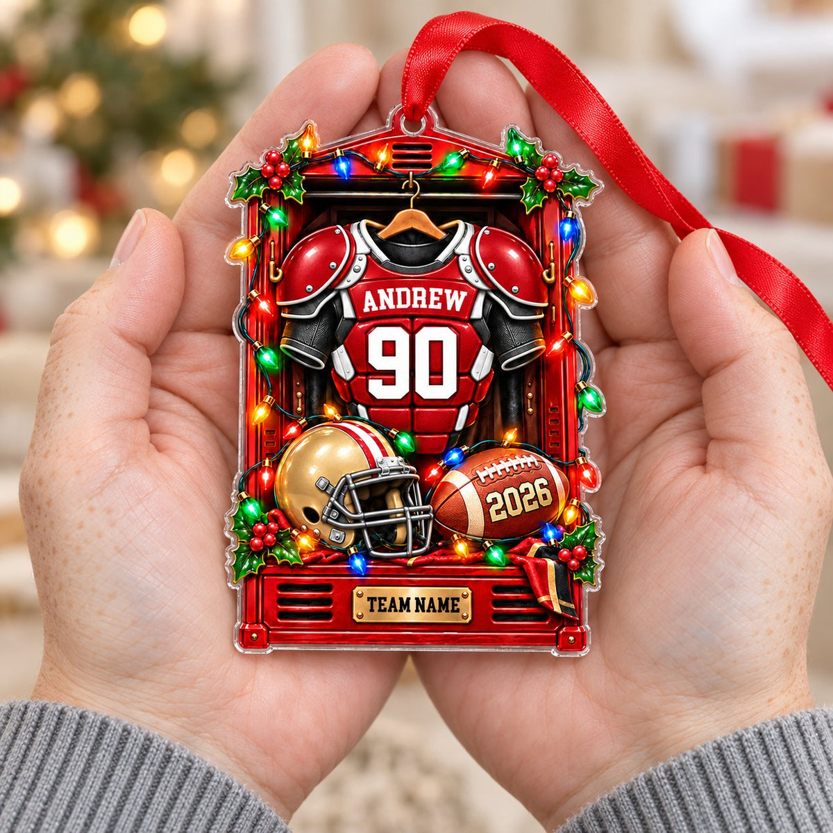 Acrylic ornament with a red football locker, jersey on hanger, gold helmet, brown football and gold plaque