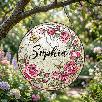 Round stained-glass style suncatcher with pink roses, two yellow butterflies, green leaves, and a decorative patterned b