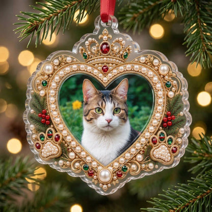 Acrylic ornament with a cat photo framed by gold filigree, jeweled crown, faux pearls, holly and paw prints on an ornate