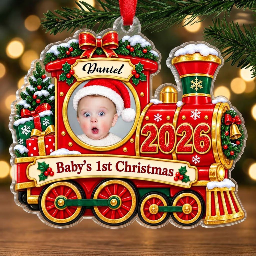 Red and gold train ornament with circular baby photo, bow, holly, wreath and 'Baby's 1st Christmas' on a scroll banner.