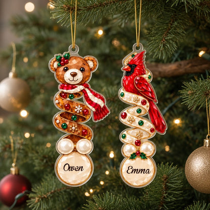 Clear acrylic ornament with a teddy bear or penguin in gem-detailed spiral style, personalized with names.