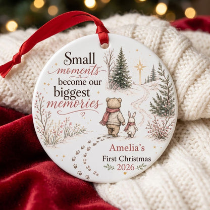 Round ceramic ornament with bear and bunny in scarves on snowy path, trees, star, quote, and personalized name and year.
