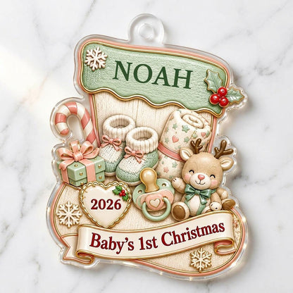 Stocking-shaped acrylic ornament with baby booties, reindeer toy and Baby's 1st Christmas on a cream banner.