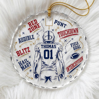 Round faceted glass ornament with football player back view, goalpost, football, and play diagrams in navy, dark red, an