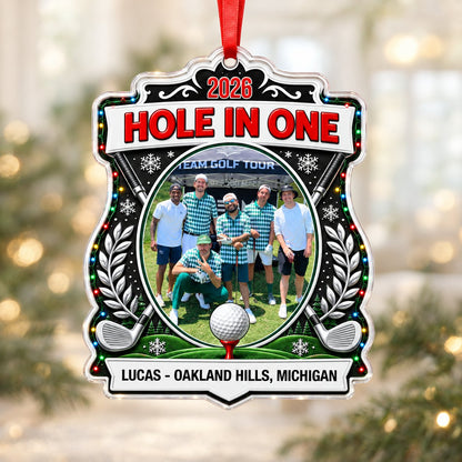Acrylic crest ornament with golf photo, crossed clubs, Christmas lights, snowflakes, and HOLE IN ONE 2026 text.