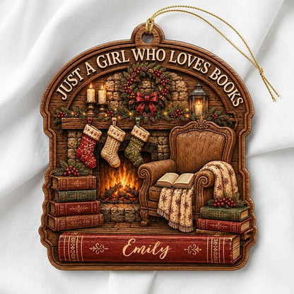 Wood ornament with fireplace, wreath, stockings, armchair and books, plus 'Just a Girl Who Loves Books' and a name.