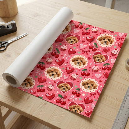 Pink gift wrap with light brown puppy faces, hearts, cherries, cupcakes, bows and sparkles in a repeating pattern