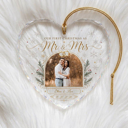 Heart-shaped glass ornament with photo, gold wedding rings, pine branches, snowflakes, and Mr & Mrs text.