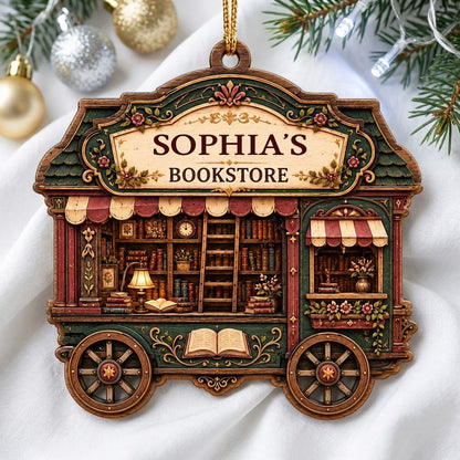 Custom-cut wood ornament shaped like a vintage bookstore wagon with books, ladder, and striped awnings.
