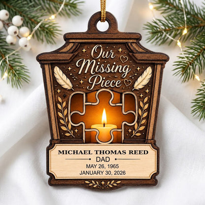 Wood ornament with lantern-style frame, puzzle-piece cutout revealing candle glow, “Our Missing Piece” text and feather 