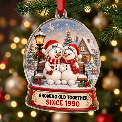 Acrylic snowglobe ornament with two snowmen on a bench, Santa hats, and Growing Old Together text.
