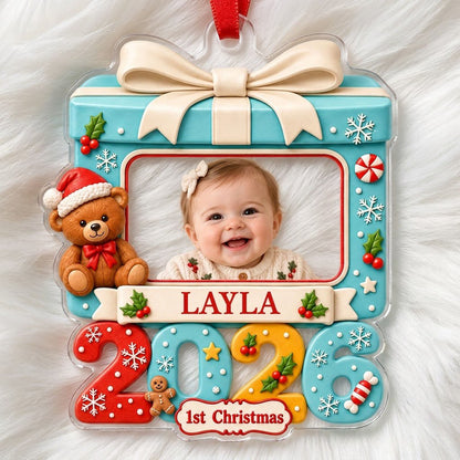 Light blue gift-box photo ornament with cream bow, teddy bear, red trim, and colorful 2026 base with 1st Christmas.