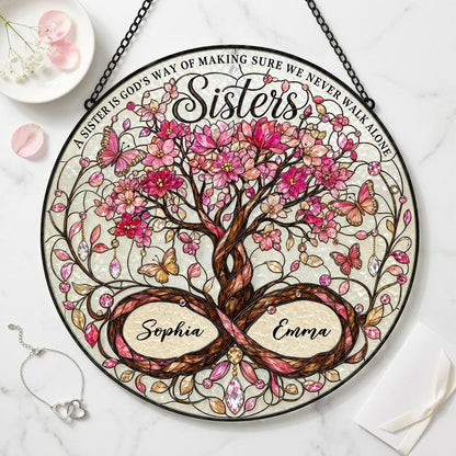 Round stained glass suncatcher with tree of life, pink blossoms, butterflies, and Sisters text with two names.