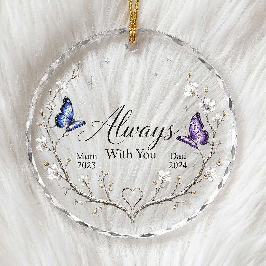 Round glass ornament with branch wreath, white blossoms, blue and purple butterflies, and Always With You text.