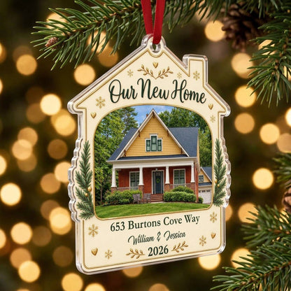 House-shaped acrylic ornament with “Our New Home”, a house photo frame, pine boughs, gold hearts and snowflakes.
