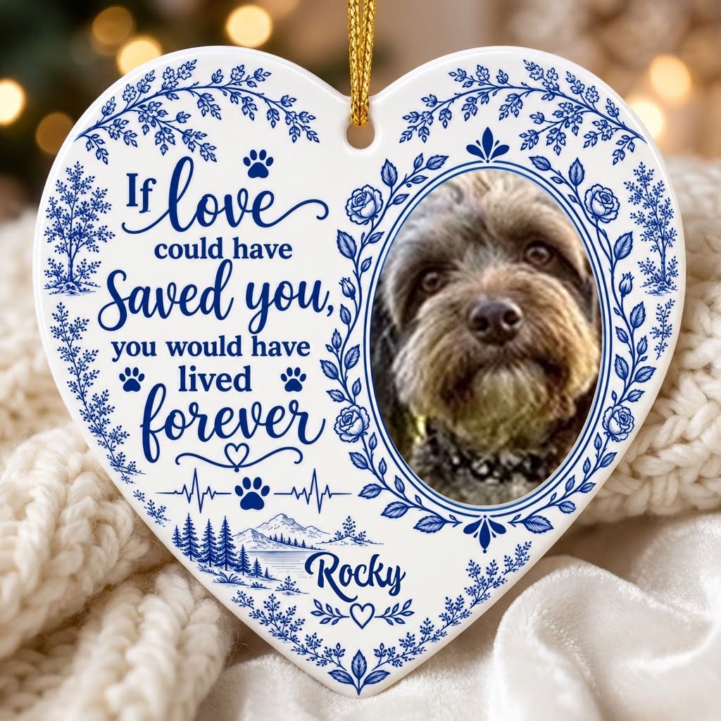 White heart ceramic ornament with blue dog photo frame wreath, memorial quote, paw heartbeat, and a mountain lake scene.