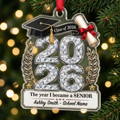 Custom-cut clear acrylic ornament shaped like a graduation cap with Class of 2026, diploma, laurels, and name plaque.