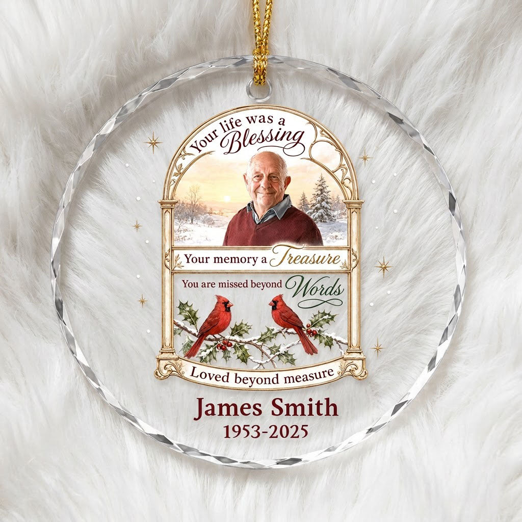 Round glass ornament with golden arched photo frame, two red cardinals on snowy pine and a memorial quote.