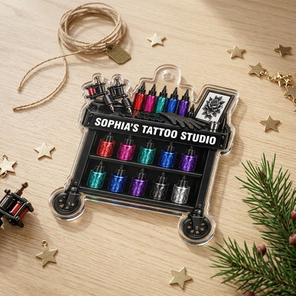 Acrylic ornament shaped like a tattoo cart with machines, colorful inks, and 'SOPHIA'S TATTOO STUDIO' text.
