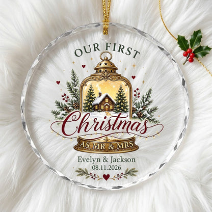 Round glass ornament with gold lantern, cozy cabin, pine branches, holly berries, and Our First Christmas as Mr & Mrs.