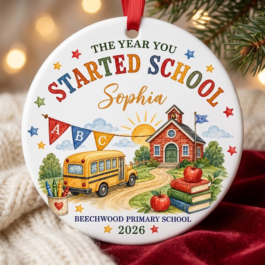 Round ceramic ornament with watercolor school bus, red brick schoolhouse, ABC bunting, books, apples, and colorful stars