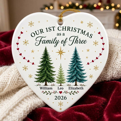 Heart ceramic ornament with three watercolor pine trees, a gold star, red heart garlands, and names with year.