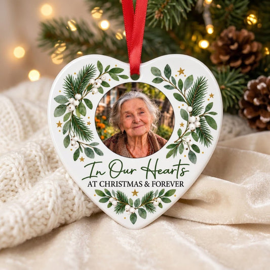 Heart ceramic ornament with In Our Hearts and AT CHRISTMAS & FOREVER around a circular photo frame with green foliage.