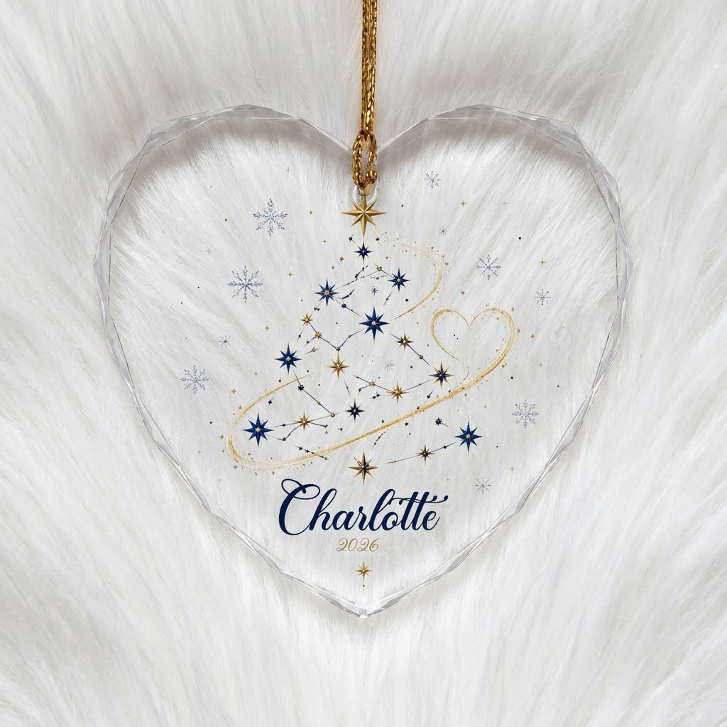Heart-shaped stained glass suncatcher with a starry Christmas tree, gold ribbon heart, and snowflakes.