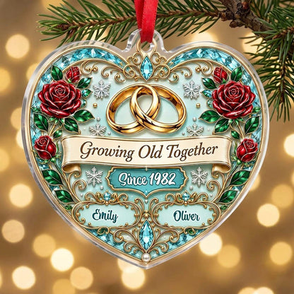 Heart-shaped clear acrylic ornament with golden rings, red roses, “Growing Old Together,” and custom names with a since 