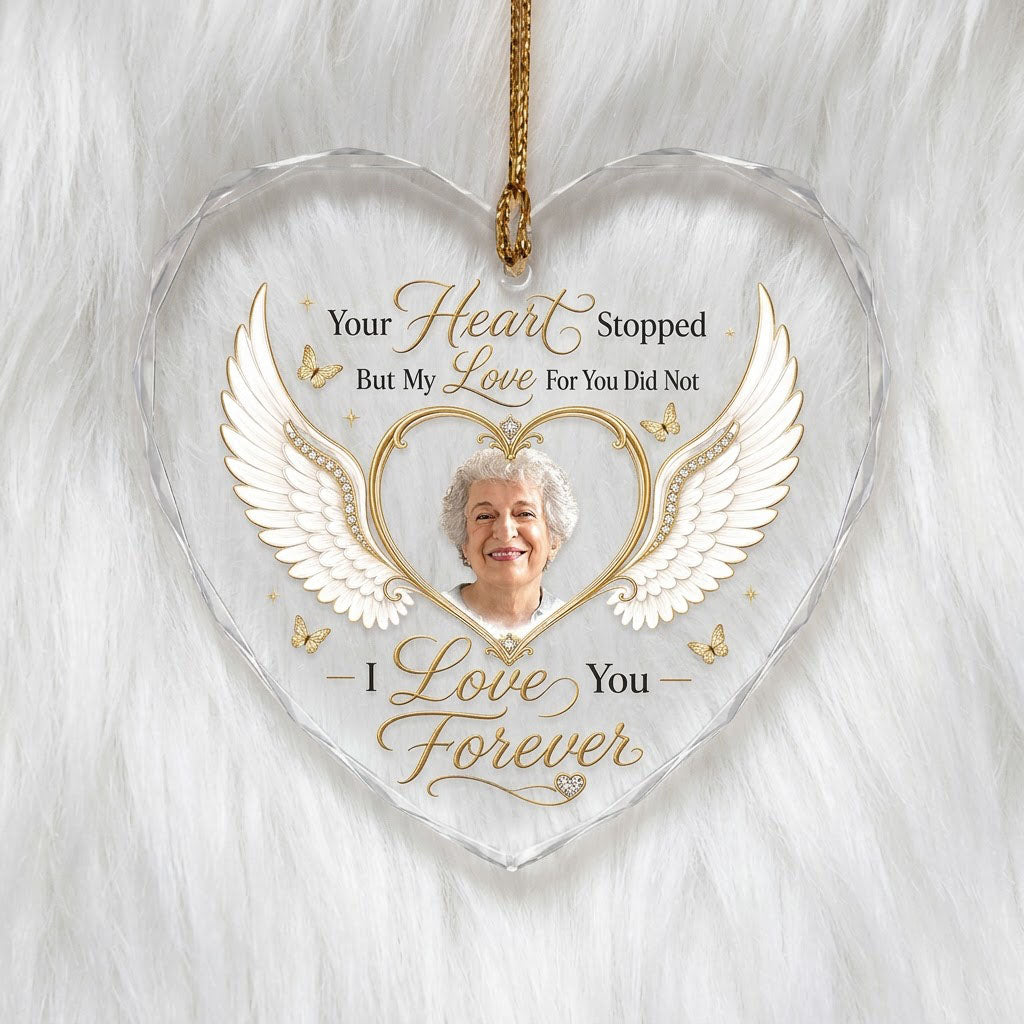Heart-shaped glass ornament with white angel wings, gold heart photo frame, golden butterflies and sparkles.