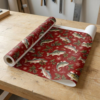 Red Christmas wrapping paper with largemouth bass and rainbow trout, some in Santa hats, pine branches, pinecones, berri