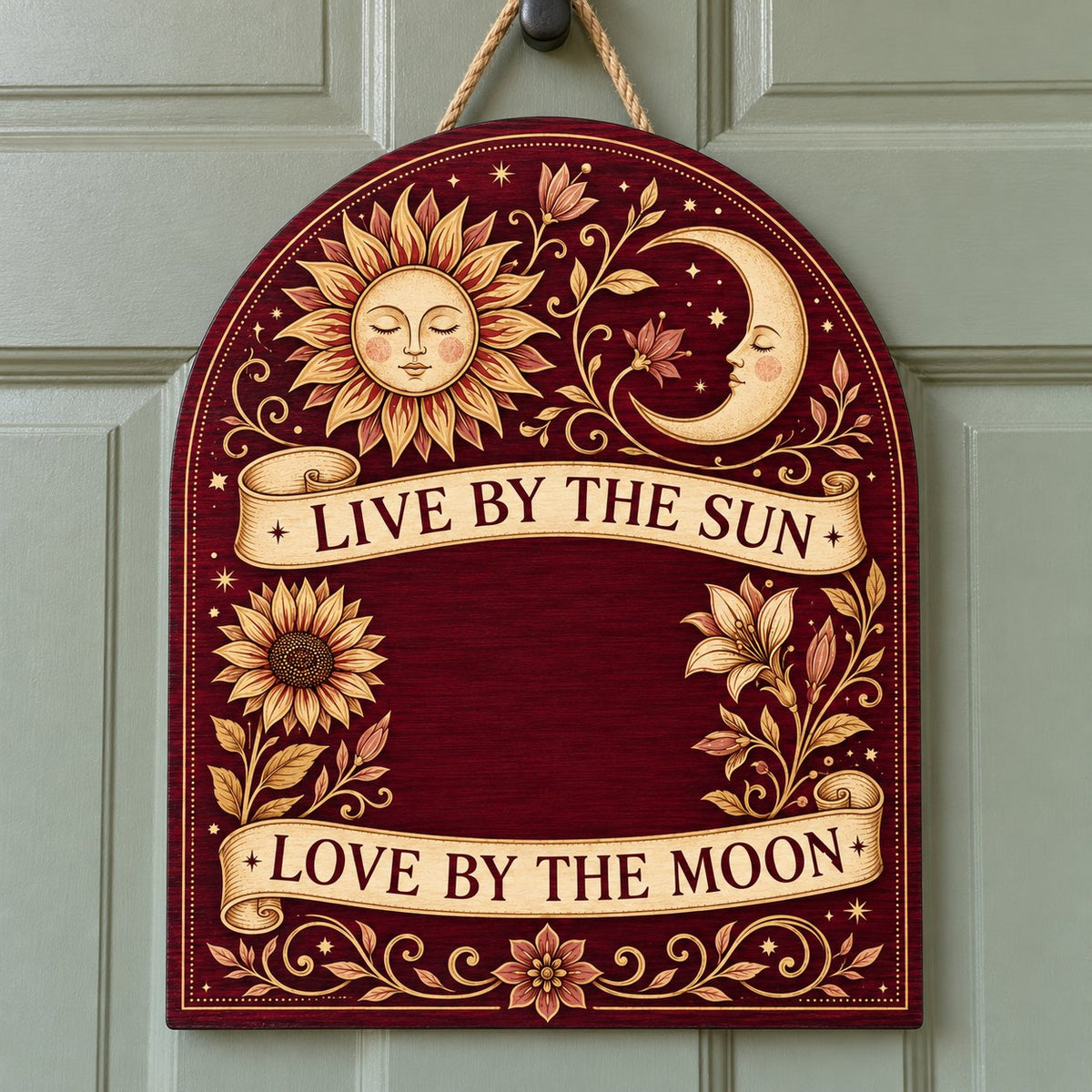 Arch sign with sleeping sun and moon, sunflower and lilies, banners reading Live by the Sun and Love by the Moon.