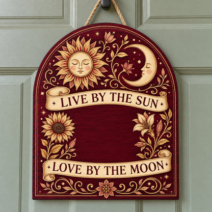 Arch sign with sleeping sun and moon, sunflower and lilies, banners reading Live by the Sun and Love by the Moon.