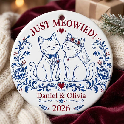 Round ceramic ornament with two wedding cats, 'JUST MEOWIED!', names and year with blue and red folk floral accents
