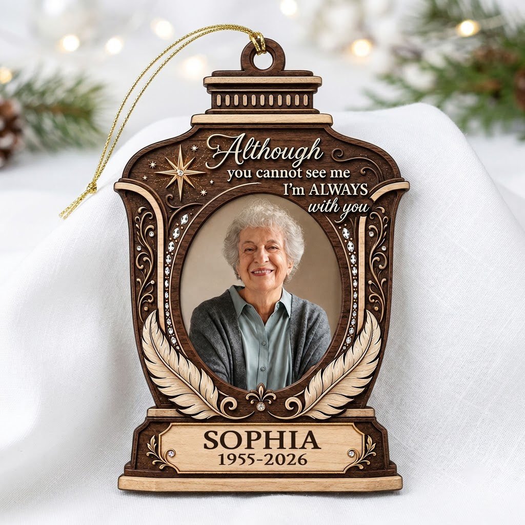 Lantern-shaped memorial wood ornament with oval photo, two feathers, starburst, fleur-de-lis and scrollwork accents.