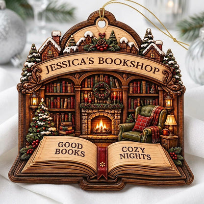 Custom-cut wood ornament with arched loop and open book base, cozy bookshop scene with tree, fireplace, armchair.