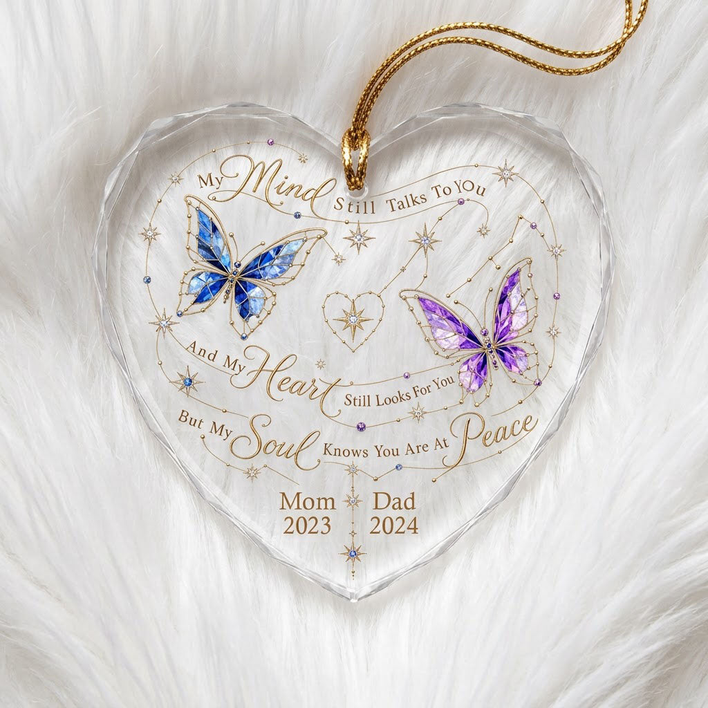 Heart-shaped glass ornament with blue and purple stained-glass butterflies, gold swirls, and memorial text.