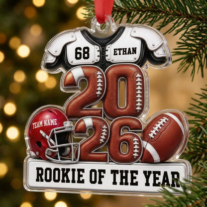 Acrylic ornament shaped like football gear with 2026 numbers, red helmet, ball and 'Rookie of the Year' nameplate.