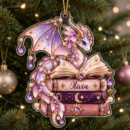 Pastel purple and gold dragon on an open book atop stacked books with jewels and pearls on a clear acrylic ornament.