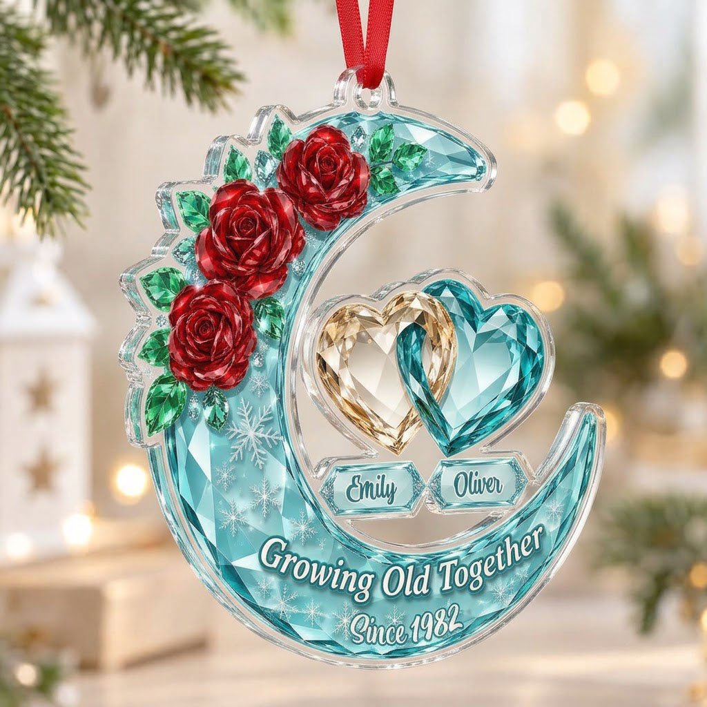 Custom-cut acrylic ornament of a faceted crescent moon with red roses, snowflakes, and two intertwined crystal hearts.