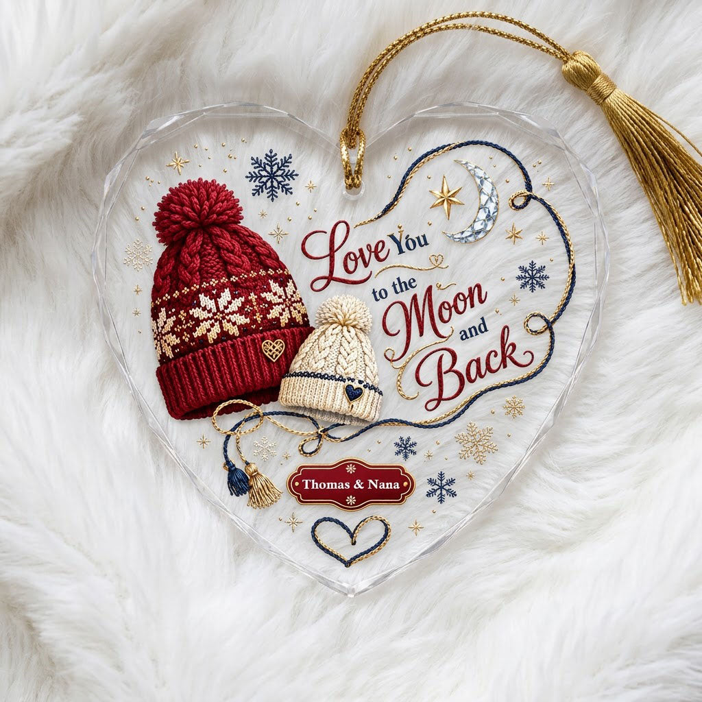 Heart glass ornament with red and cream pom-pom beanies, silver moon, gold star, and Love You Moon and Back text.
