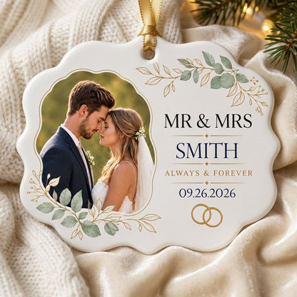 White scalloped ceramic medallion with MR & MRS, eucalyptus, gold rings, and a couple’s photo on the left.