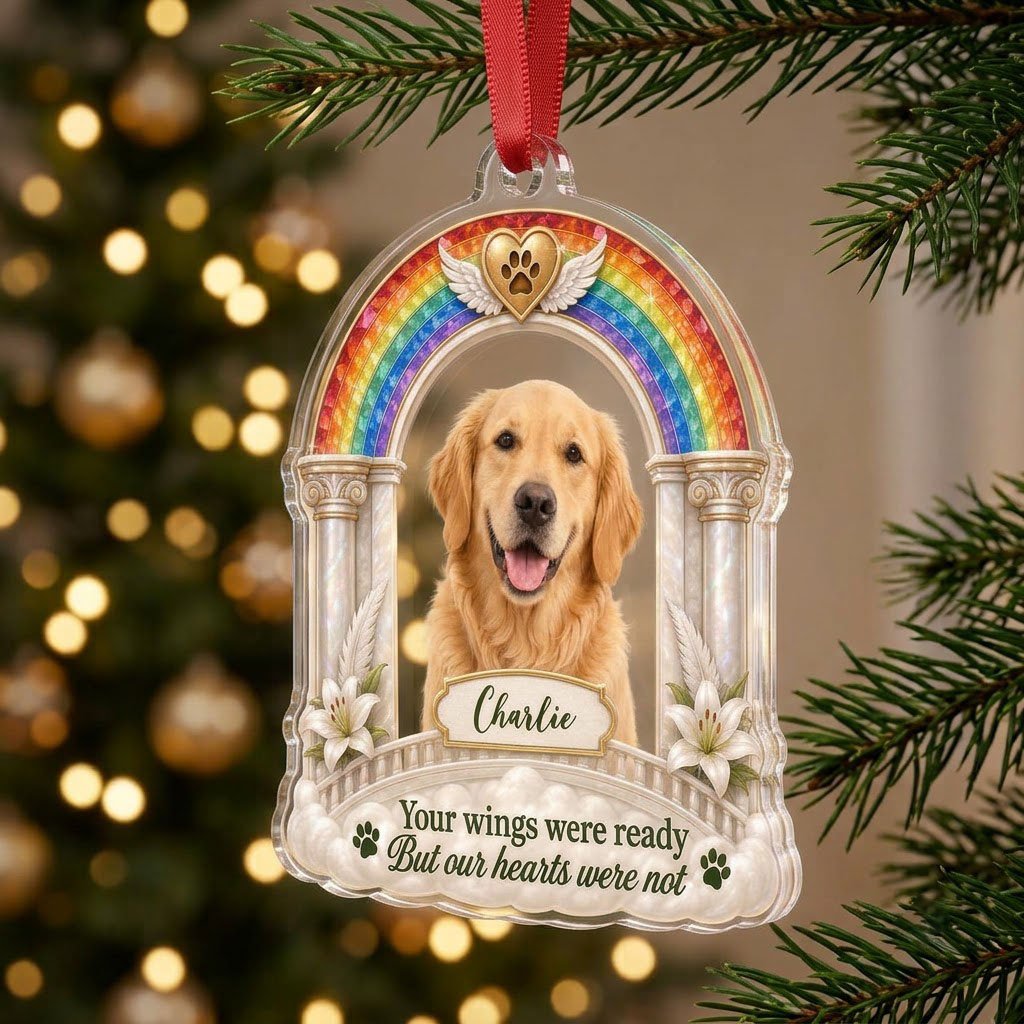 A rainbow arch pet memorial acrylic ornament with a winged golden heart, paw print, lilies, pillars, clouds and a photo 