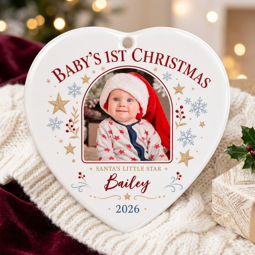 Heart ceramic ornament with arched photo frame, gold stars, blue snowflakes, holly, and 'Baby's 1st Christmas' text.