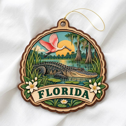 Scalloped wood ornament with alligator, pink spoonbill, sun, cypress trees, and 'FLORIDA' on a bottom banner.
