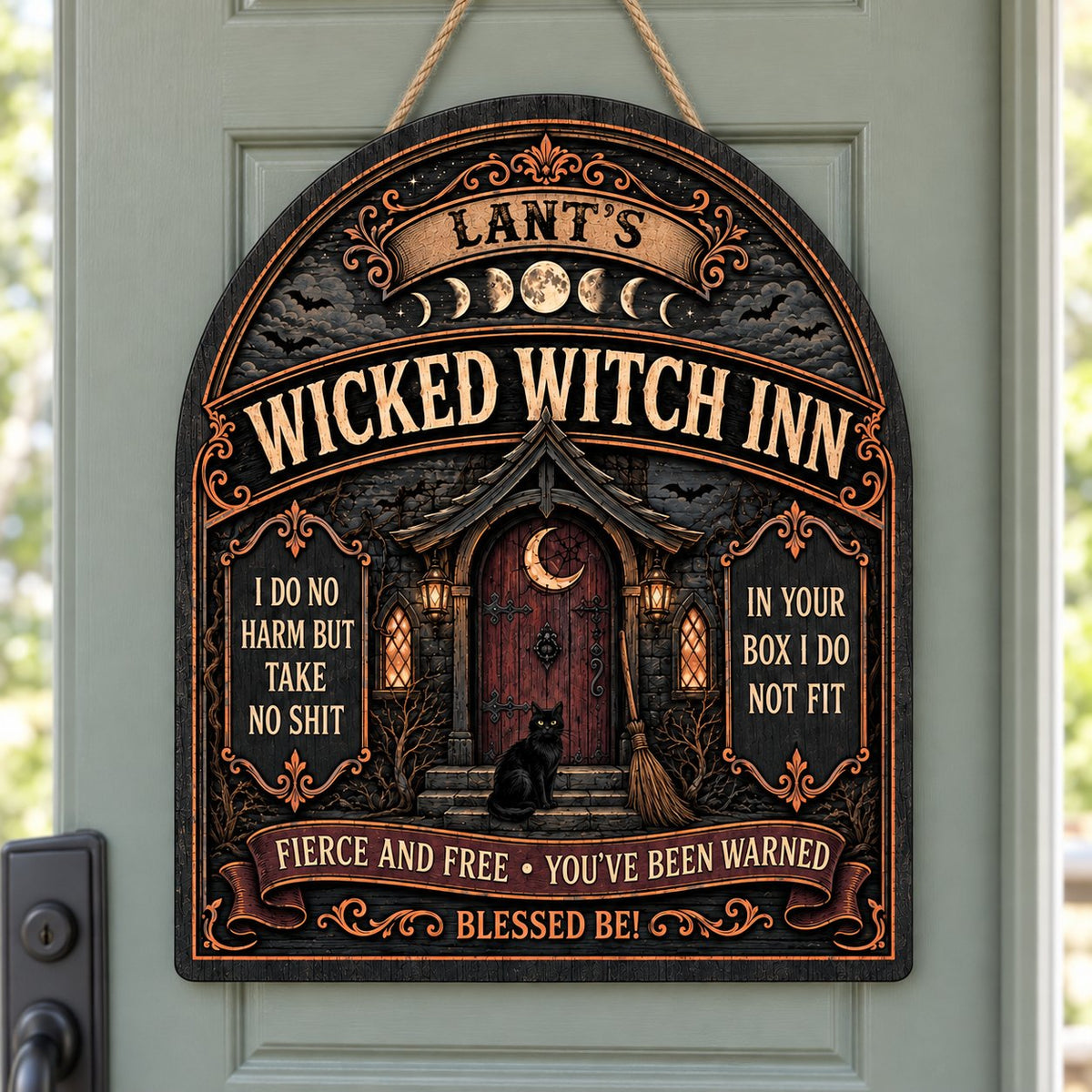 Arch wooden sign with a witch's cottage, bats, moon phases, red crescent door, broom, and a black cat on the steps.