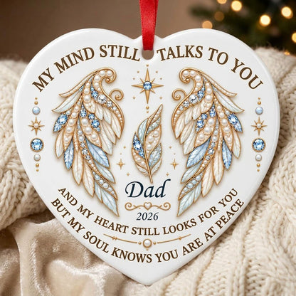 White heart ceramic ornament with jeweled angel wings, blue gems, gold scrollwork, personalized name and year.