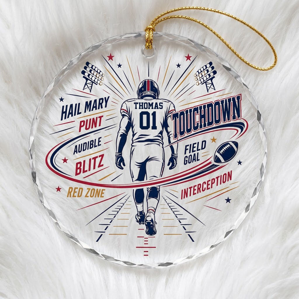 Round faceted glass ornament with football player back view, stadium lights, navy swoosh, and name and number.